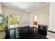 Spacious living room with black tile, plantation shutters, and doors leading to outdoor area, perfect for entertaining at 7 Rue Promenade Way, Henderson, NV 89011
