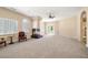 Spacious living room with a fireplace, large windows, and access to a patio at 7 Rue Promenade Way, Henderson, NV 89011