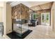 Stylish living room features a modern fireplace, stone accent walls, and access to the backyard at 7 Rue Promenade Way, Henderson, NV 89011