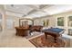 Living room features a billiards table, stone archway, elegant seating, and seamless access to outdoor living at 7 Rue Promenade Way, Henderson, NV 89011