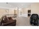 View of a spacious loft featuring a comfortable couch, massage chair, and access to a modern laundry room at 7 Rue Promenade Way, Henderson, NV 89011