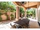 Inviting outdoor patio with overhead lighting, lush landscaping, and comfortable seating at 7 Rue Promenade Way, Henderson, NV 89011