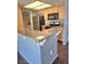 Updated kitchen featuring stainless steel appliances, light wood cabinets, and a granite countertop bar at 7100 Pirates Cove Rd # 1099, Las Vegas, NV 89145