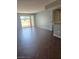 Spacious living room featuring tile flooring, access to balcony, and kitchen counter with bar stools at 7100 Pirates Cove Rd # 1099, Las Vegas, NV 89145