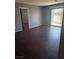 The open-concept living room features tile flooring and a sliding door to a balcony at 7100 Pirates Cove Rd # 1099, Las Vegas, NV 89145