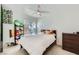 Bright bedroom featuring a ceiling fan, window, and decorative accents at 7127 S Durango Dr # 310, Las Vegas, NV 89113