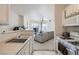 Efficient kitchen with appliances, white cabinets, and view into the living room creating an open feel at 7127 S Durango Dr # 310, Las Vegas, NV 89113