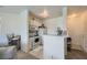 Compact kitchen featuring essential appliances, white cabinetry, and a breakfast bar at 7127 S Durango Dr # 310, Las Vegas, NV 89113