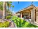 Spacious backyard with a covered patio, well-maintained lawn, mature trees, and room for outdoor activities at 7311 Chaparral Cove Ln, Las Vegas, NV 89131