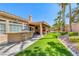 Inviting backyard features a built-in bar, covered patio, and well-manicured lawn perfect for relaxation and entertainment at 7311 Chaparral Cove Ln, Las Vegas, NV 89131