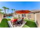 Fully landscaped backyard with artificial grass, lounge chairs, and patio area with access to the pool at 7311 Chaparral Cove Ln, Las Vegas, NV 89131
