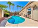 Inviting backyard pool and spa, set amongst lush landscaping and mature palm trees, with outdoor seating at 7311 Chaparral Cove Ln, Las Vegas, NV 89131