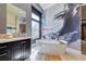 Stylish free-standing tub with designer mural detail with granite vanity and natural light at 7311 Chaparral Cove Ln, Las Vegas, NV 89131