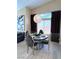 Charming dining room with contemporary light fixture, neutral tones, and a large window providing natural light at 7311 Chaparral Cove Ln, Las Vegas, NV 89131