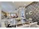 Stylish dining room with modern chandelier, designer wallpaper, and open layout at 7311 Chaparral Cove Ln, Las Vegas, NV 89131