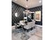 Elegant dining room features designer wallpaper, stylish lighting, and a modern table, great for gatherings at 7311 Chaparral Cove Ln, Las Vegas, NV 89131