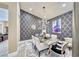 Chic dining room features stylish wallpaper, elegant lighting, and seating for six at 7311 Chaparral Cove Ln, Las Vegas, NV 89131