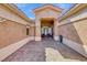 Inviting front courtyard with brick pavers and a covered seating area at 7311 Chaparral Cove Ln, Las Vegas, NV 89131