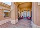 Covered front patio featuring brick pavers, comfortable seating, and stylish decor at 7311 Chaparral Cove Ln, Las Vegas, NV 89131