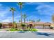 Gorgeous single-story home with a three-car garage, beautiful landscaping and palm trees at 7311 Chaparral Cove Ln, Las Vegas, NV 89131