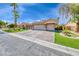Charming single-story home with lush green landscaping and a paver driveway at 7311 Chaparral Cove Ln, Las Vegas, NV 89131