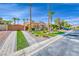 Beautiful single-story home with desert landscaping, palm trees, and a paver driveway at 7311 Chaparral Cove Ln, Las Vegas, NV 89131
