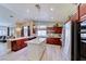 Beautiful kitchen with dark wood cabinets, a center island with a marble countertop, and modern appliances at 7311 Chaparral Cove Ln, Las Vegas, NV 89131