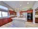 Spacious kitchen with an island, stainless steel appliances, and cherry wood cabinets at 7311 Chaparral Cove Ln, Las Vegas, NV 89131