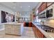 The kitchen is equipped with stone countertops, high end appliances and wooden cabinets at 7311 Chaparral Cove Ln, Las Vegas, NV 89131