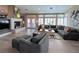 Spacious living room boasts a fireplace, ample seating, and large windows offering abundant natural light and style at 7311 Chaparral Cove Ln, Las Vegas, NV 89131
