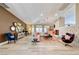 Spacious living room with modern furnishings, statement art, and a cozy fireplace at 7311 Chaparral Cove Ln, Las Vegas, NV 89131