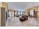 Open living room with hardwood floors, dining area, and lots of natural light at 7311 Chaparral Cove Ln, Las Vegas, NV 89131