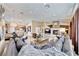 Expansive living room with fireplace flows to chef's kitchen and dining area with modern finishes at 7311 Chaparral Cove Ln, Las Vegas, NV 89131