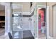 Modern glass shower, sleek tile, and updated fixtures with secondary bathroom in the background at 7311 Chaparral Cove Ln, Las Vegas, NV 89131