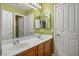Bathroom with double sinks, cabinets and mirror, as well as access to shower at 7340 Elderly Ave, Las Vegas, NV 89131