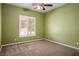 Simple bedroom with carpet flooring, ceiling fan, and shuttered windows with natural light at 7340 Elderly Ave, Las Vegas, NV 89131