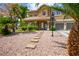Charming two-story home featuring desert landscaping, a stepping stone walkway, and a two-car garage at 7340 Elderly Ave, Las Vegas, NV 89131