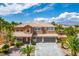 Inviting two-story home showcasing a well-maintained yard, mature palms, and a spacious two-car garage at 7340 Elderly Ave, Las Vegas, NV 89131