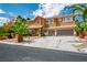 Stunning two-story home with desert landscaping, mature palm trees, and a spacious driveway leading to a two-car garage at 7340 Elderly Ave, Las Vegas, NV 89131