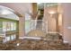Bright foyer with marble floors, staircase with white railing, and archway leading to living area at 7340 Elderly Ave, Las Vegas, NV 89131