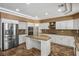 Large kitchen featuring white cabinets, stainless steel appliances, and center island with granite countertop at 7340 Elderly Ave, Las Vegas, NV 89131