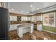 Spacious kitchen featuring granite counters, stainless steel appliances, and a center island at 7340 Elderly Ave, Las Vegas, NV 89131