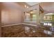 Open-concept living room featuring tile flooring, grand pillars, and ample natural light, creating an inviting atmosphere at 7340 Elderly Ave, Las Vegas, NV 89131