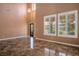 Elegant living room with soaring ceilings, tile flooring, plantation shutters, and an abundance of natural light at 7340 Elderly Ave, Las Vegas, NV 89131