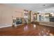 Open floor plan with hardwood floors, fireplace, and staircase leading to the second floor at 7340 Elderly Ave, Las Vegas, NV 89131