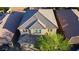 Aerial view of a home with a tile roof, brick driveway, and mature landscaping at 777 Star Apple Ln, Las Vegas, NV 89178