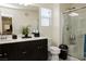Modern bathroom with a vanity, marble countertop, glass-enclosed shower, and neutral color palette at 777 Star Apple Ln, Las Vegas, NV 89178