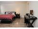 Spacious bedroom with a well-lit workspace, a comfortable platform bed, and hardwood floors throughout at 777 Star Apple Ln, Las Vegas, NV 89178