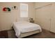 Comfortable bedroom featuring a simple bed, a side table, and sliding closet doors at 777 Star Apple Ln, Las Vegas, NV 89178