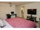 Relaxing bedroom with a TV, a neutral color scheme, and a workspace that offers comfort and functionality at 777 Star Apple Ln, Las Vegas, NV 89178